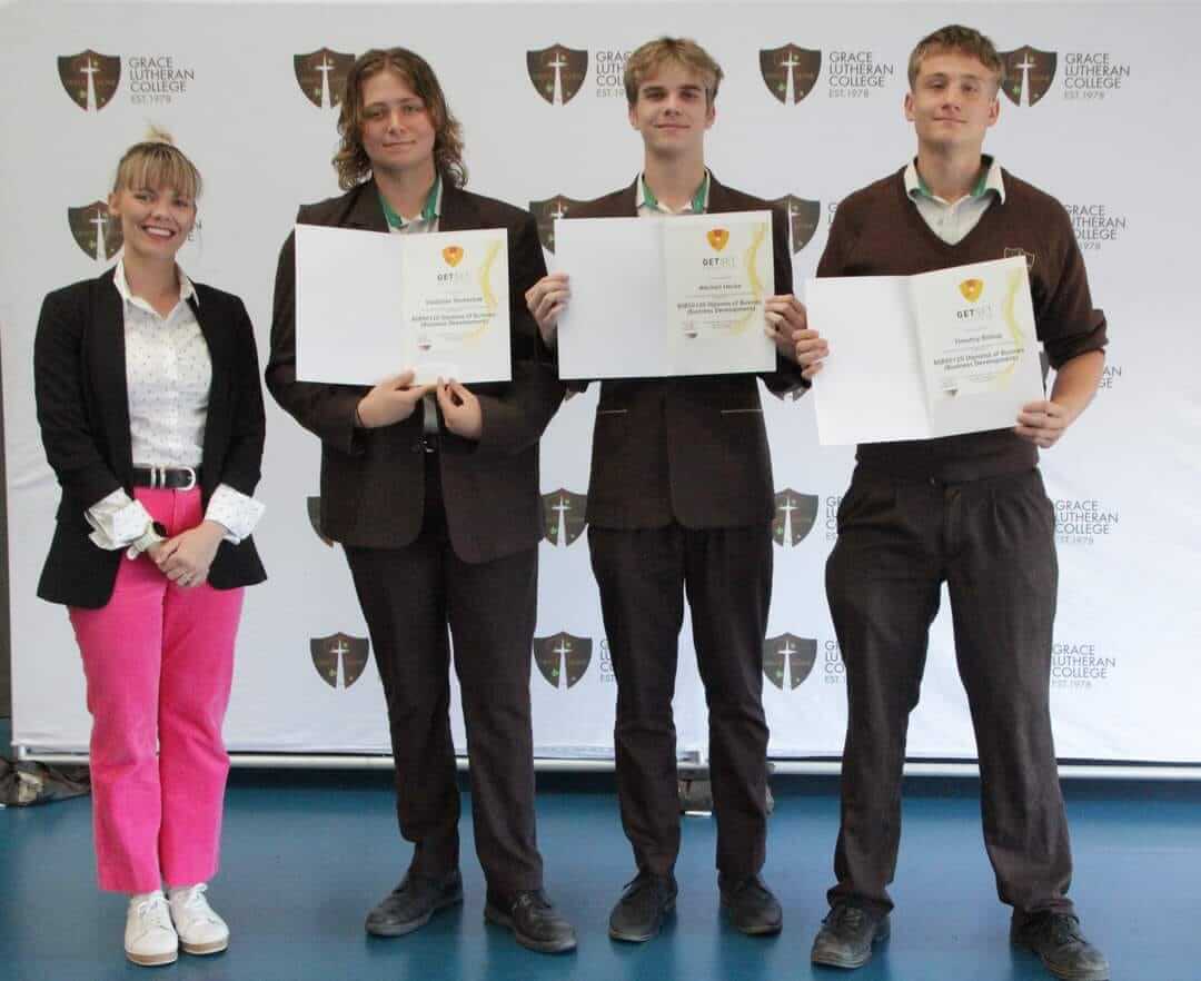 School students holding graduation certificates